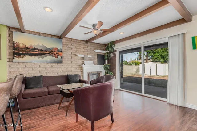 a living room with furniture and a floor to ceiling window