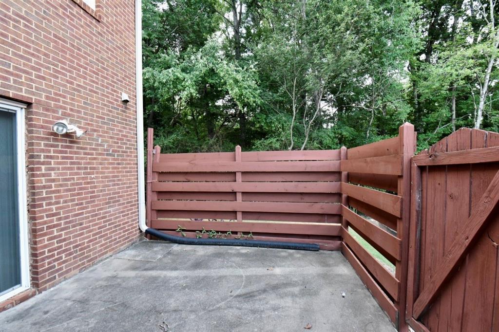 2898 Webb Bridge Road Alpharetta, GA 30009 - Photo 8 of 8 a view of a backyard with dishwasher and wooden fence