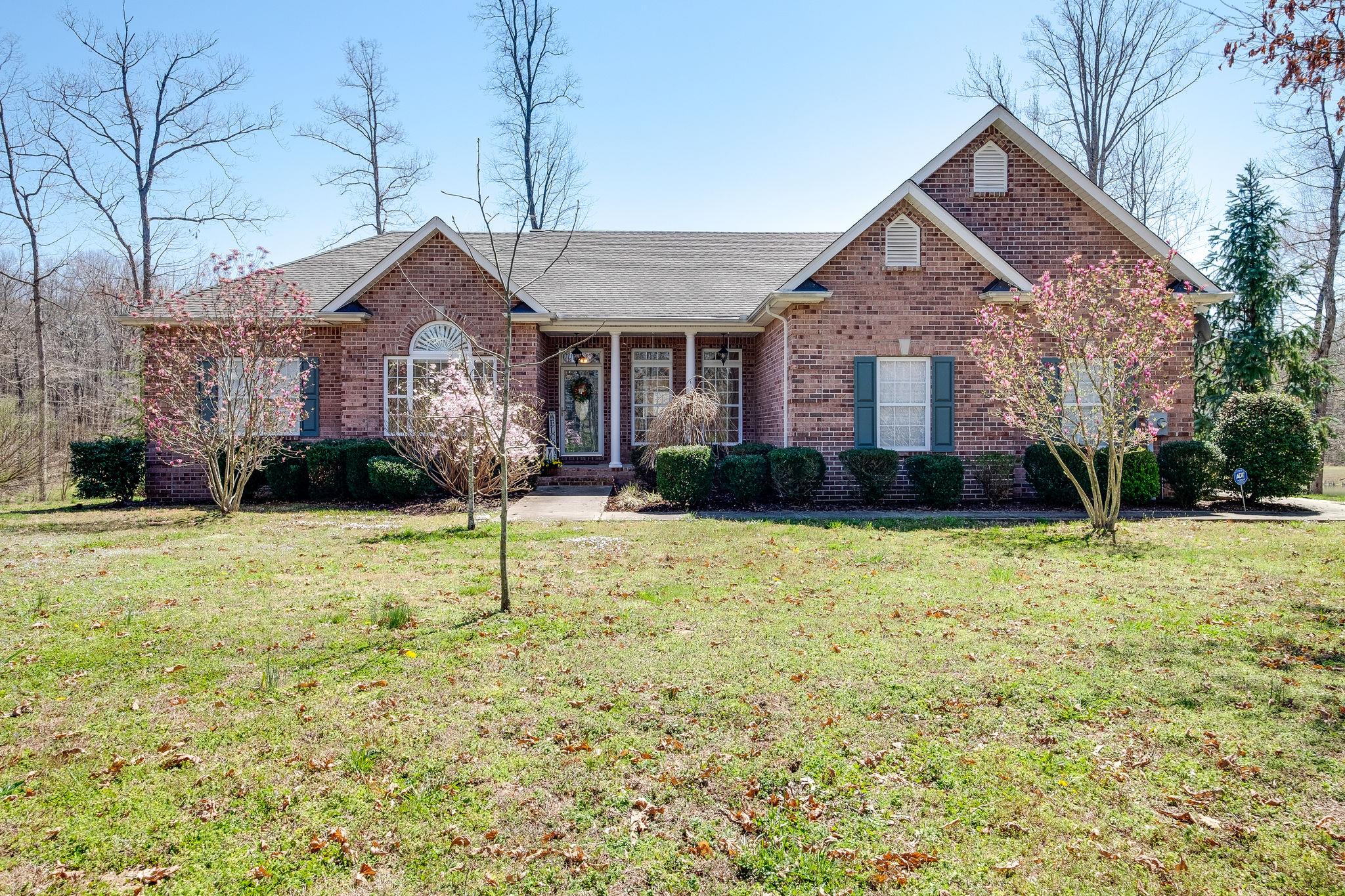1175 Tidwell Switch Road Dickson, TN 37055 - Photo 1 of 27 a front view of a house with garden