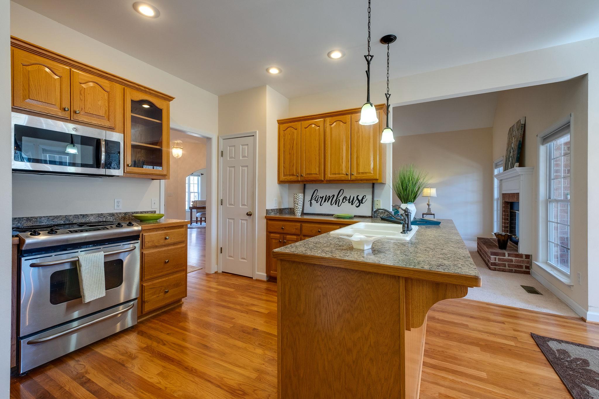 1175 Tidwell Switch Road Dickson, TN 37055 - Photo 11 of 27 a kitchen with stainless steel appliances granite countertop a sink a stove and a wooden cabinets