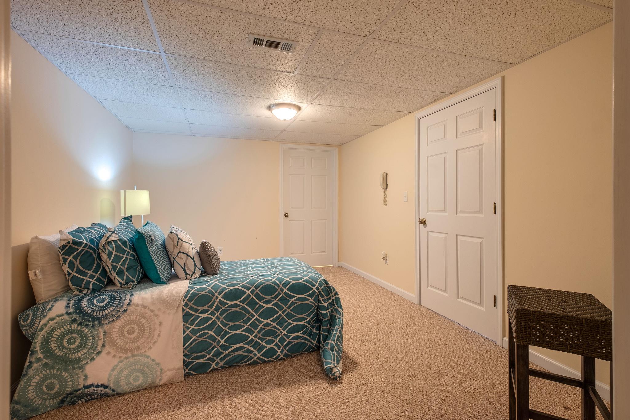1175 Tidwell Switch Road Dickson, TN 37055 - Photo 20 of 27 a spacious bedroom with a bed and a chair