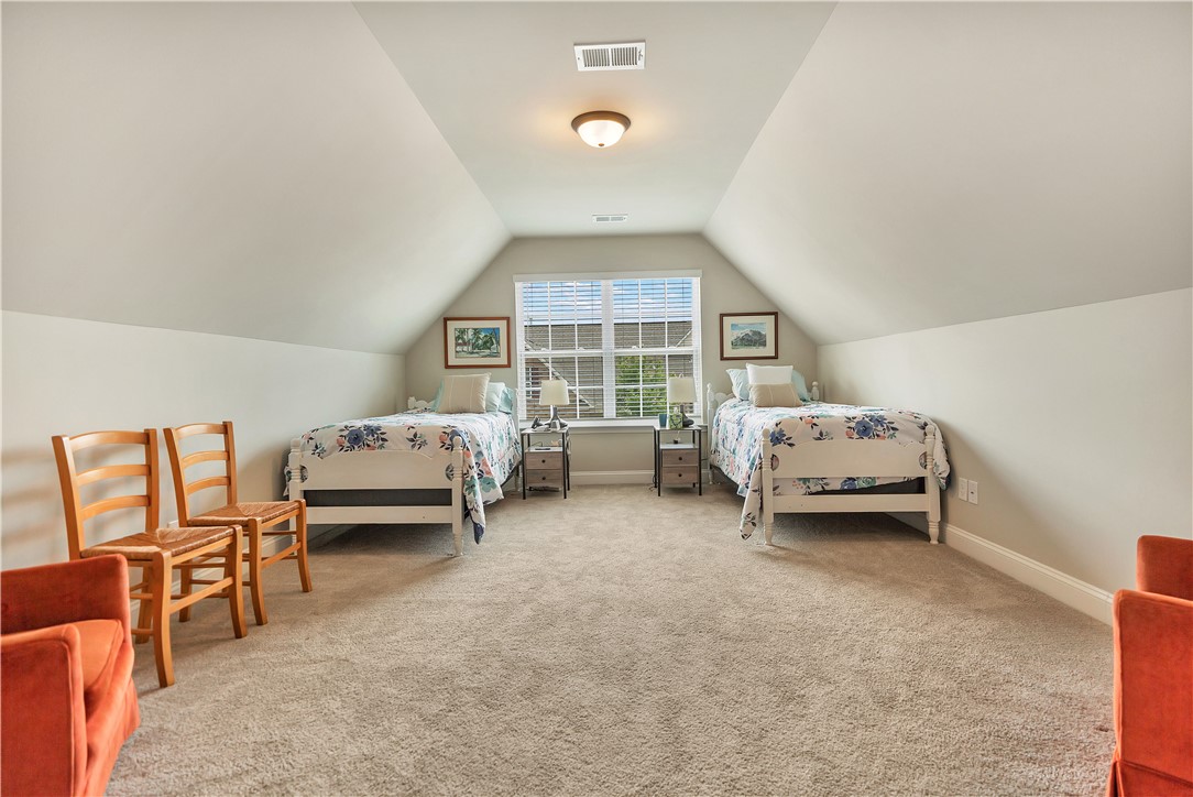 111 Coosa Lane Anderson, SC 29621 - Photo 24 of 36 Sloping ceilings create an inviting, cozy atmosphere in this spacious bedroom, perfect for a private retreat.