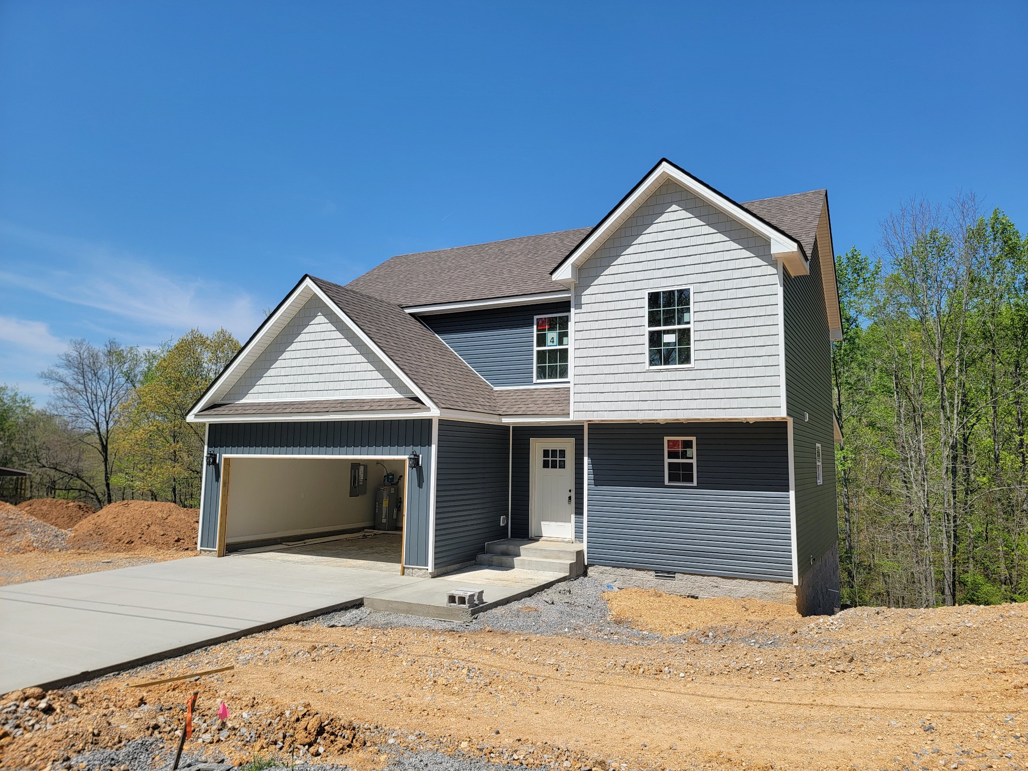 2265 Mockingbird Hill Road Palmyra, TN 37142 - Photo 1 of 24 a front view of a house with a yard and garage