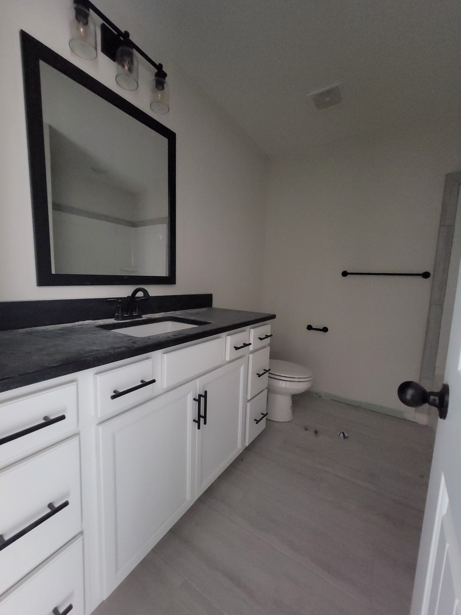 2265 Mockingbird Hill Road Palmyra, TN 37142 - Photo 18 of 24 a bathroom with a toilet sink and mirror