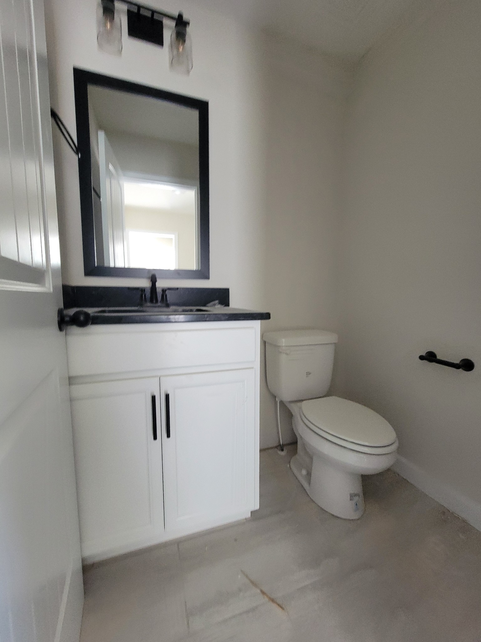 2265 Mockingbird Hill Road Palmyra, TN 37142 - Photo 23 of 24 a bathroom with a granite countertop toilet sink and mirror