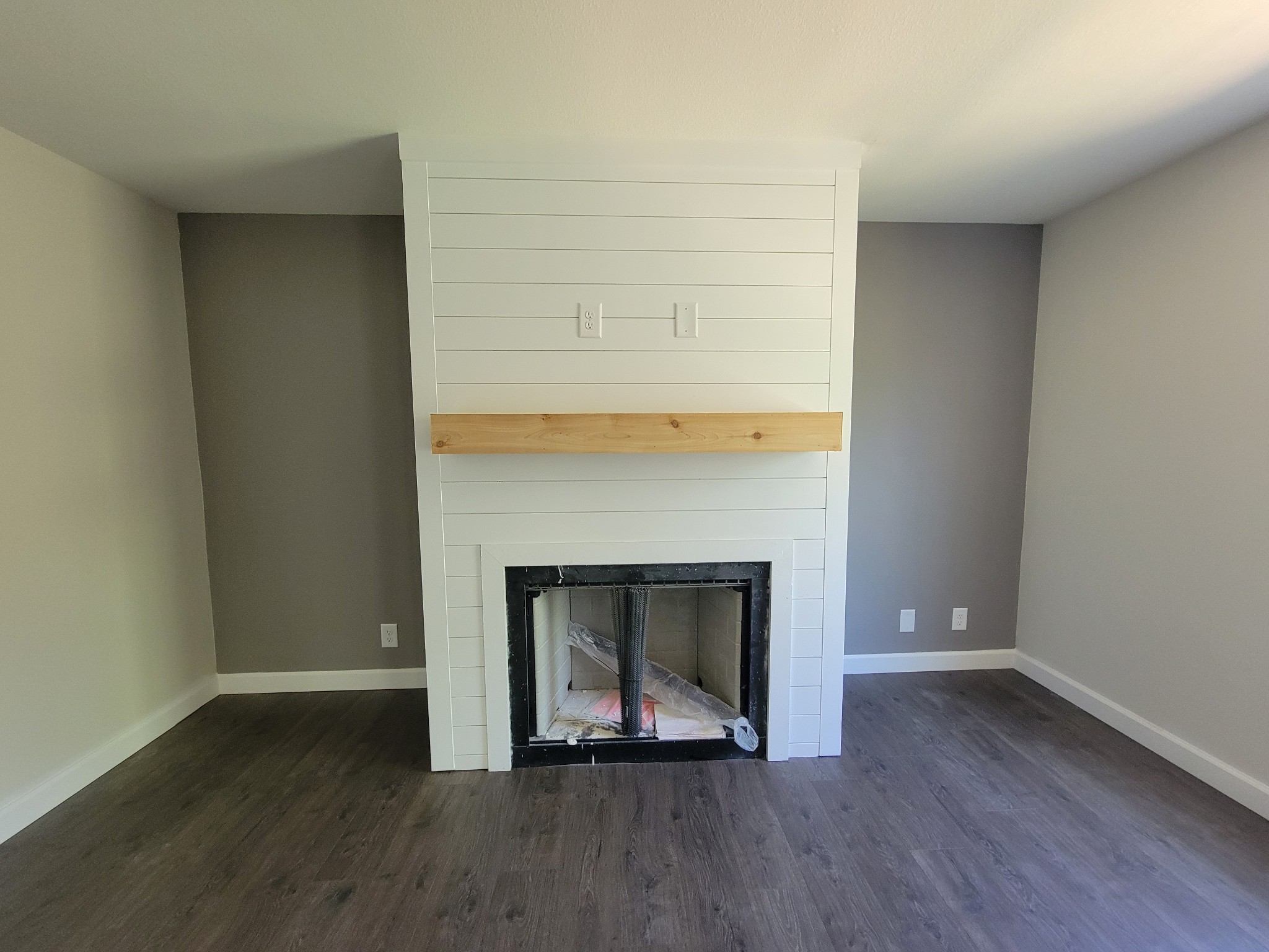 2265 Mockingbird Hill Road Palmyra, TN 37142 - Photo 7 of 24 an empty room with wooden floor and fireplace