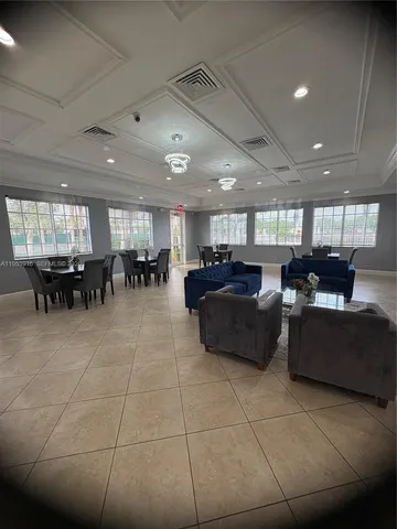 a living room with lots of furniture and a large window