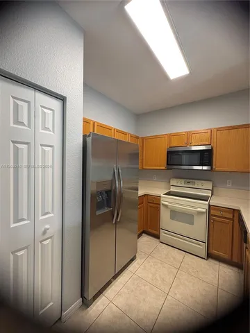 a kitchen with a refrigerator and cabinets