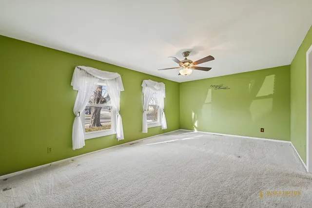 a view of a livingroom with a ceiling fan and a window