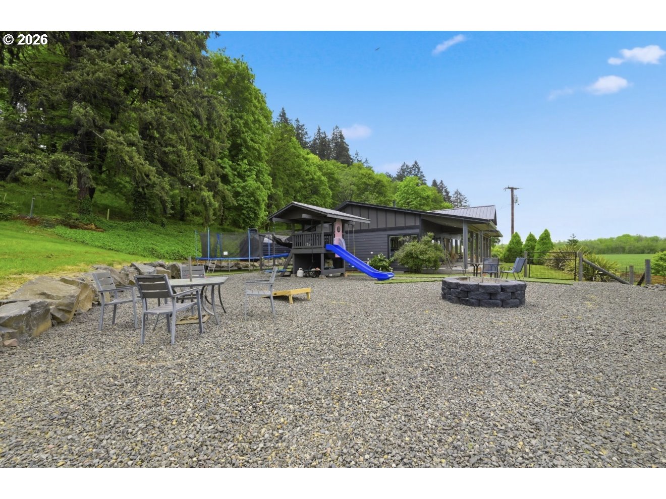 33192 Wilkins Road Eugene, OR 97408 - Photo 31 of 35 a view of a house with a backyard and a patio