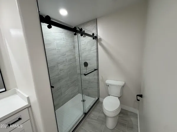 a view of a big room with wooden floor and windows