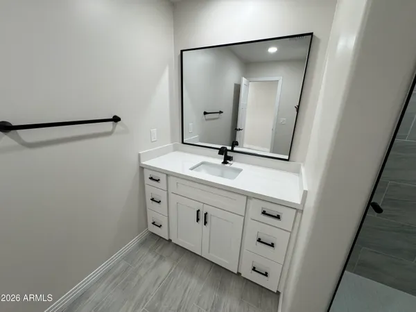 an empty room with a ceiling fan and window