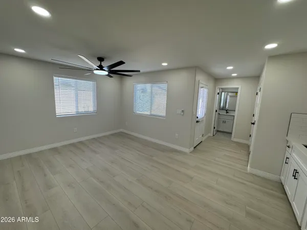 a kitchen with cabinets stainless steel appliances and a counter space