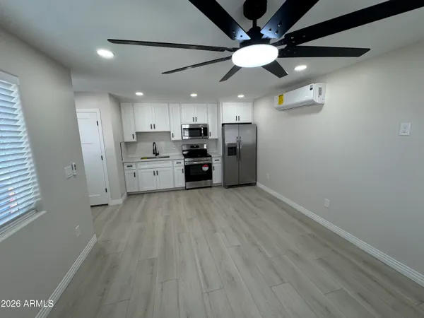 a hallway with cabinets and wooden floor