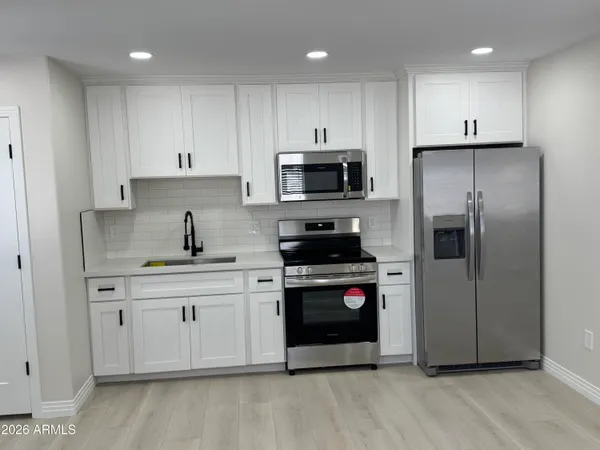 a bathroom with a toilet a sink and a mirror