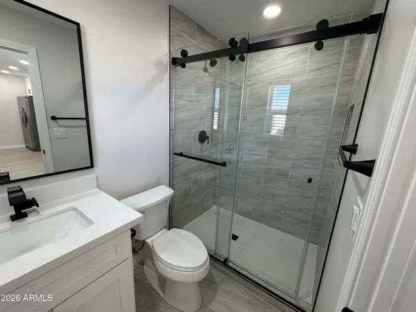 an empty room with wooden floor and entrance