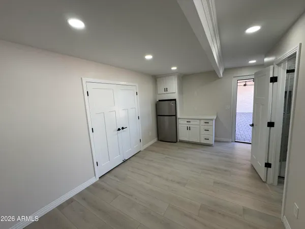 an empty room with a window and wooden floor