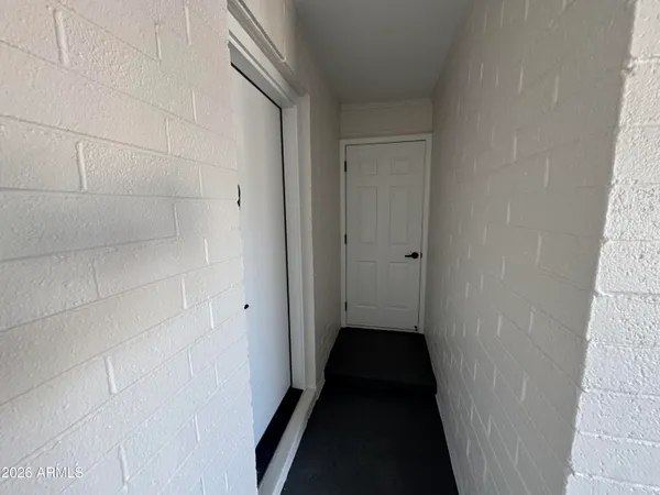 a view of an empty room with a kitchen