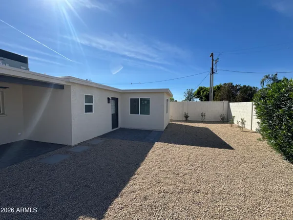a black white and yellow vase with flowers on it