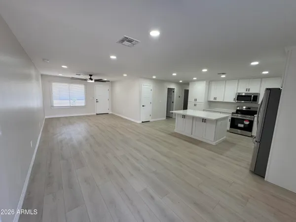 a kitchen with a sink a stove and cabinets