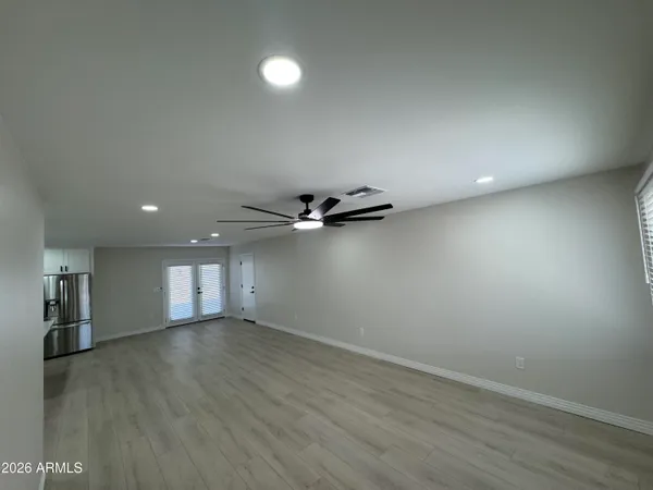 a view of an empty room with wooden floor