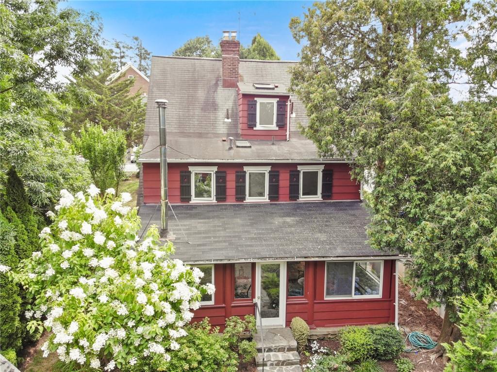 front view of a house with a tree