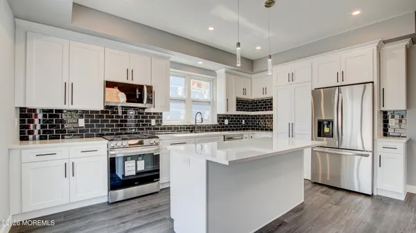 a kitchen with stainless steel appliances a refrigerator stove microwave and sink