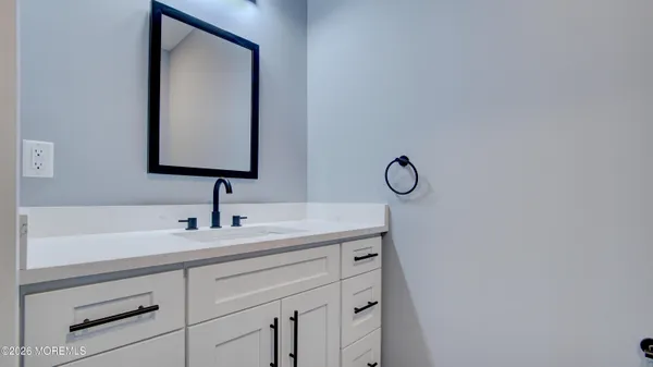 a bathroom with a sink vanity and a mirror