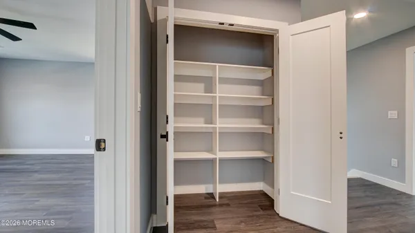a view of walk in closet with empty racks