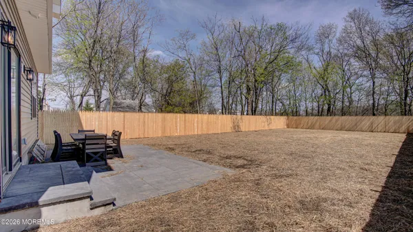 a backyard of a house with table and chairs