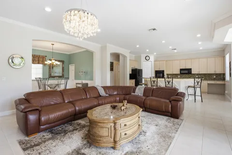 a spacious bedroom with a bed and a chandelier