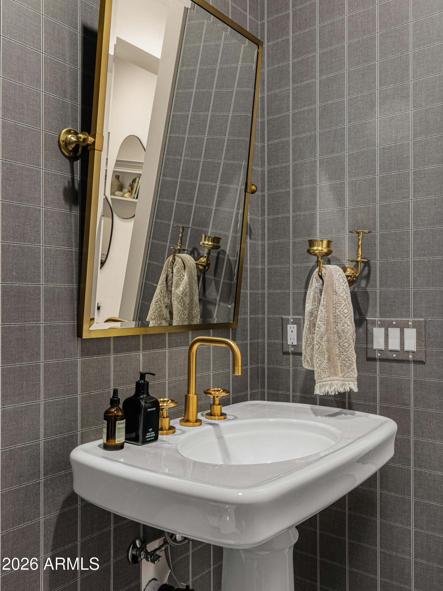 4204 North 57th Way Phoenix, AZ 85018 - Photo 30 of 34 a bathroom with a sink and a mirror