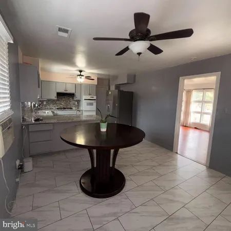 a kitchen with kitchen island stainless steel appliances a sink and a counter top space