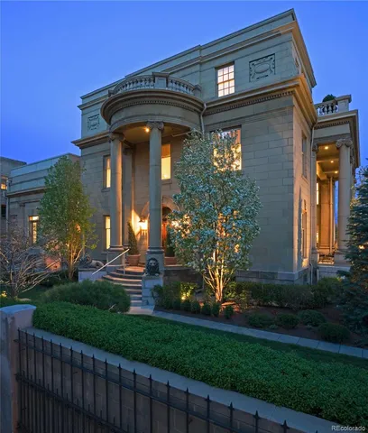 a living room with furniture a fireplace and a large window
