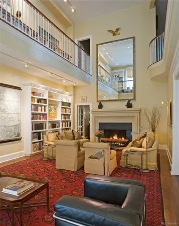 a living room with furniture a fireplace and a large window
