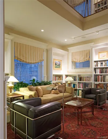 a living room with a table chairs and a dining table with wooden floor
