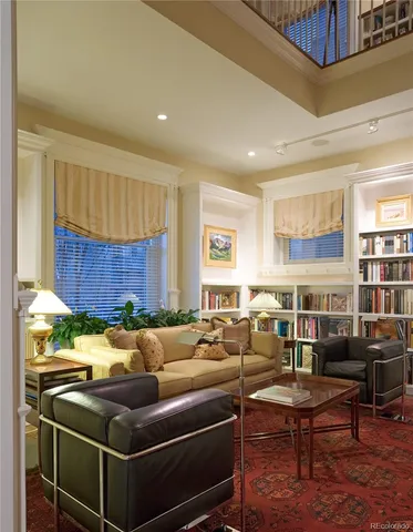a living room with a table chairs and a dining table with wooden floor