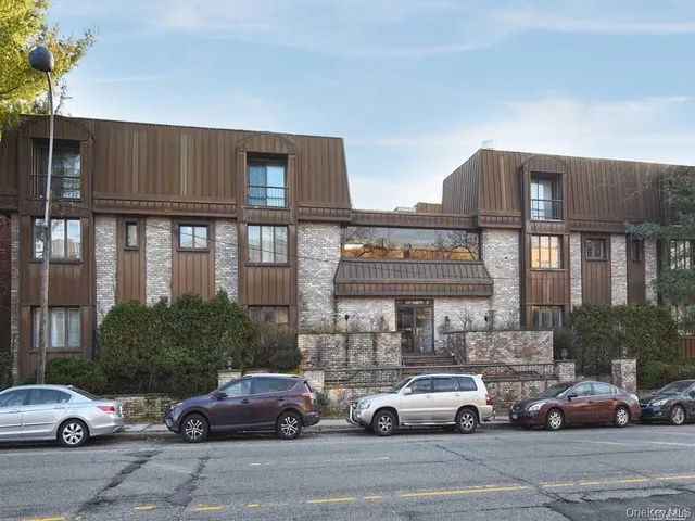a view of parking garage with cars parked