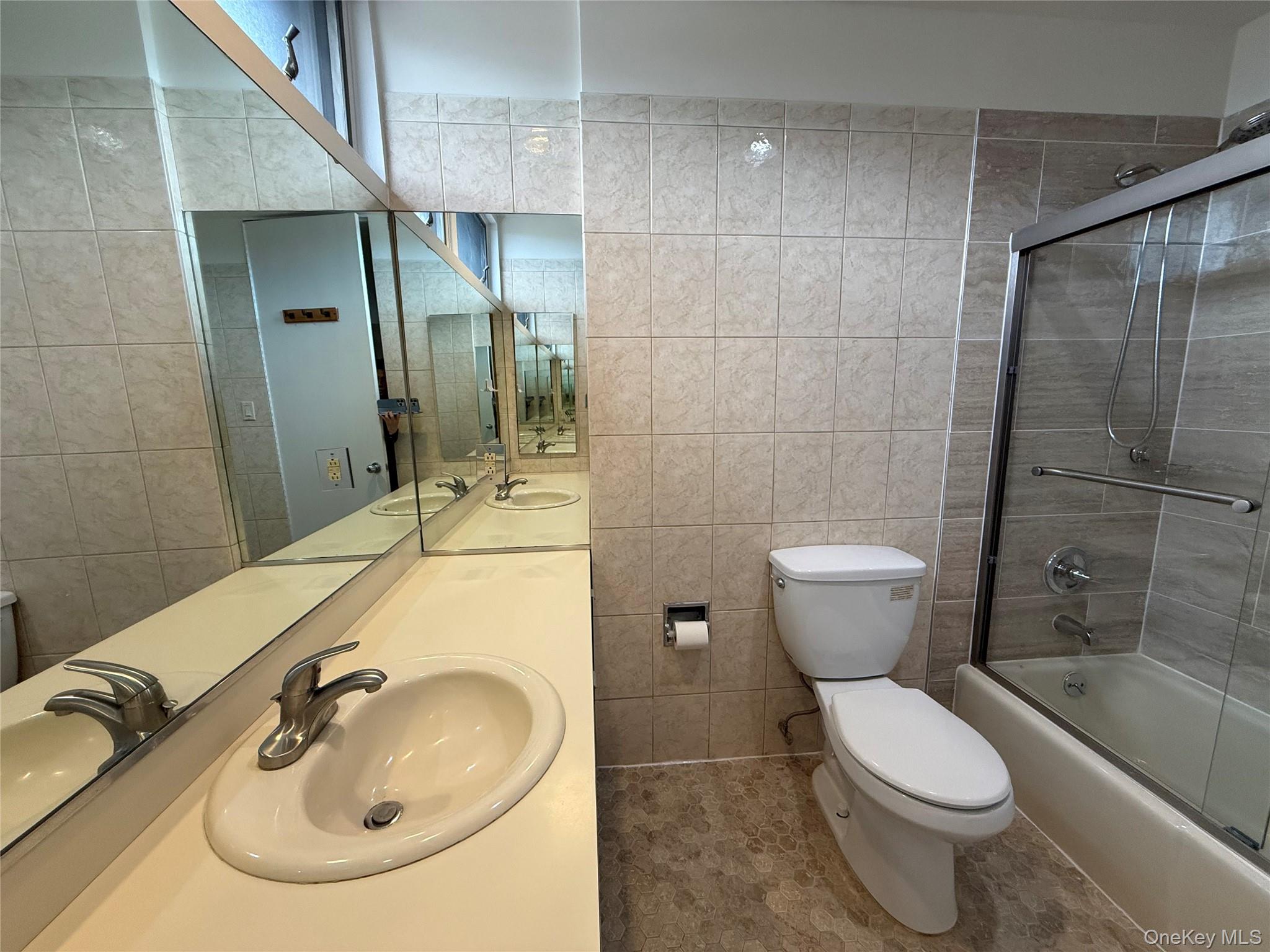 130 South Middle Neck Road, Unit 2 Great Neck, NY 11021 - Photo 17 of 22 a bathroom with a sink toilet and shower