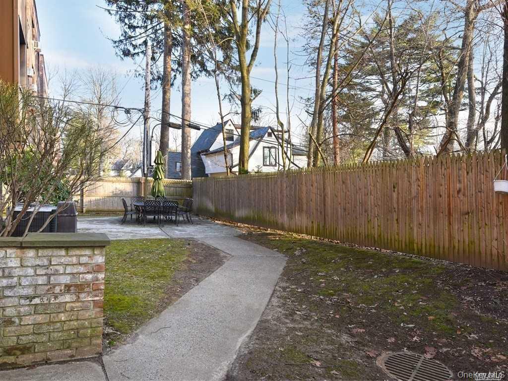 130 South Middle Neck Road, Unit 2 Great Neck, NY 11021 - Photo 19 of 22 a view of backyard with fountain and outdoor seating