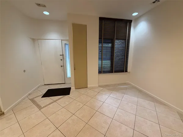 an empty room with fireplace and windows