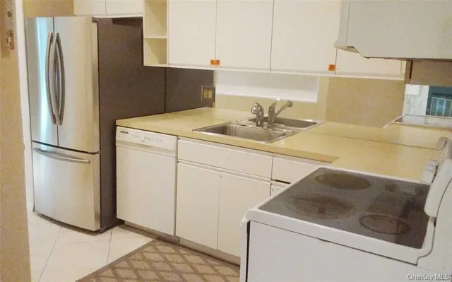 a kitchen with a stove sink and refrigerator