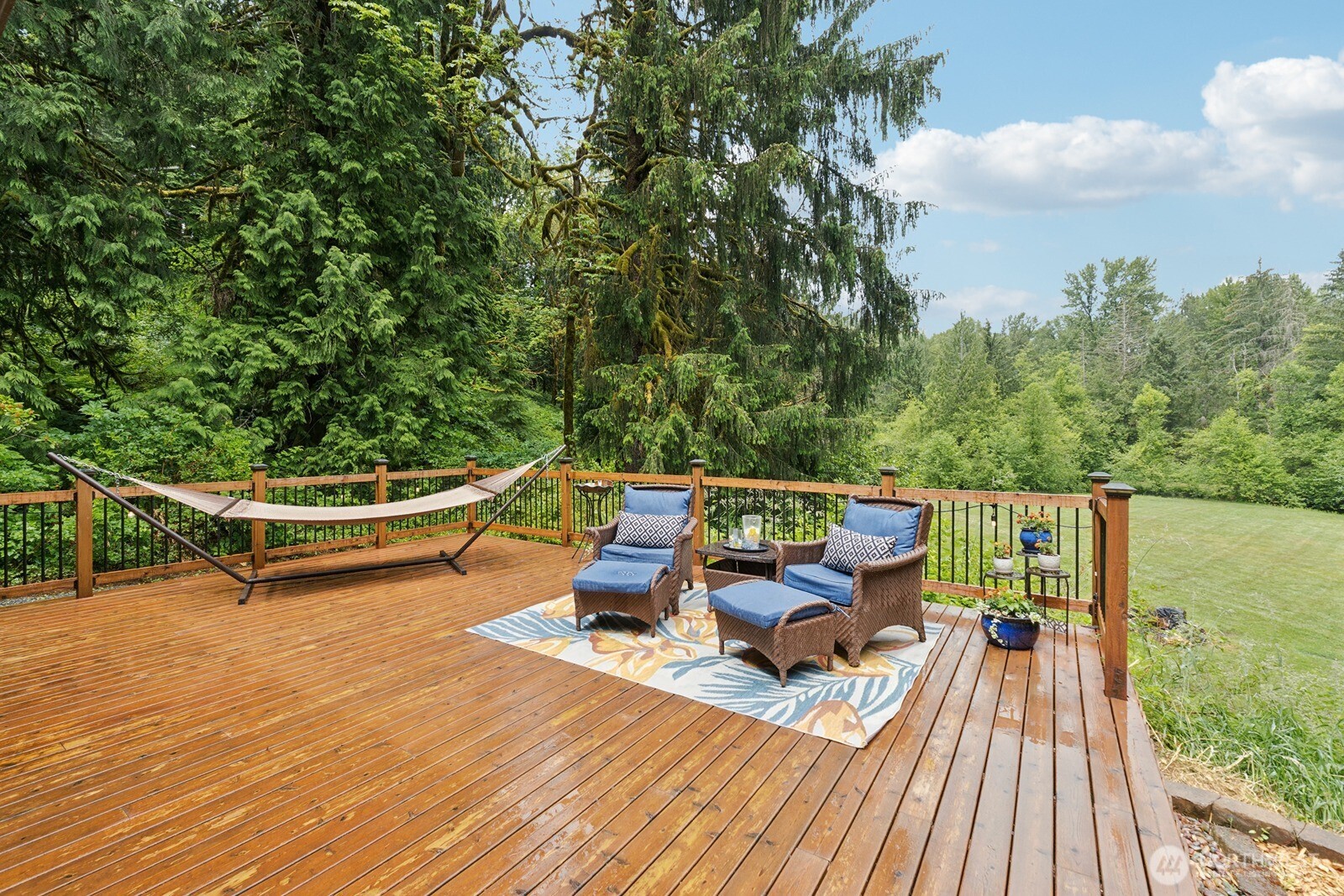 45908 Southeast Edgewick Road North Bend, WA 98045 - Photo 16 of 40 a view of a patio with lawn chairs and wooden floor