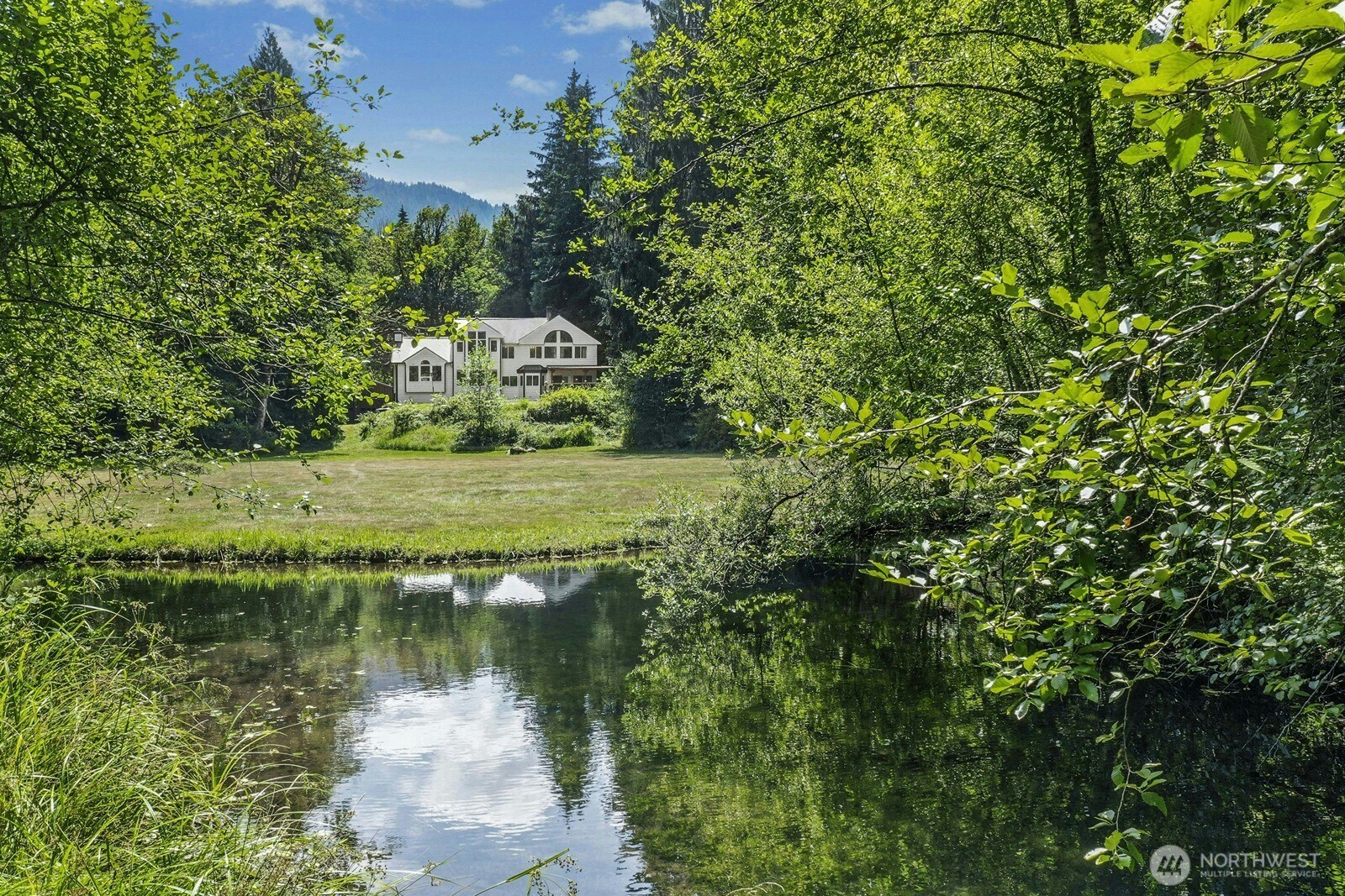45908 Southeast Edgewick Road North Bend, WA 98045 - Photo 2 of 40 a view of a lake with a building in the background