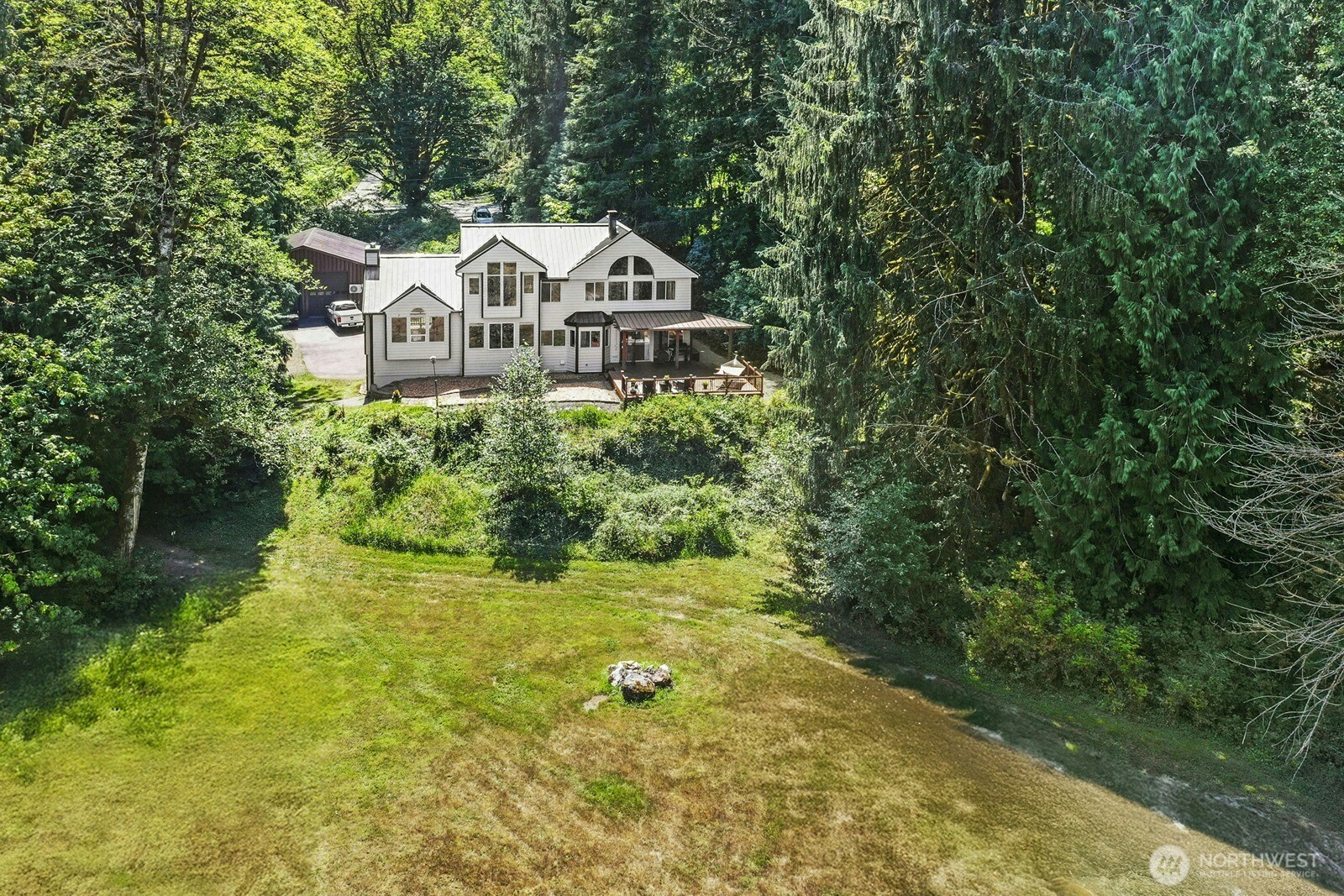 45908 Southeast Edgewick Road North Bend, WA 98045 - Photo 39 of 40 a view of a house with a small yard and large trees