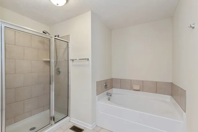a bathroom with a bathtub and shower