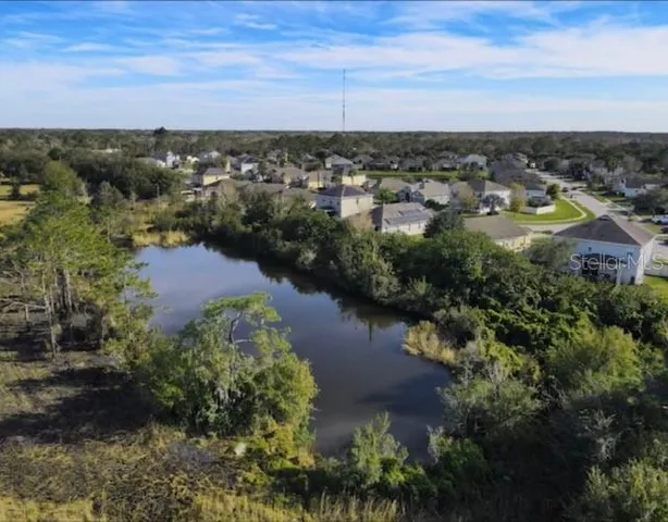 an aerial view of a city and lake view