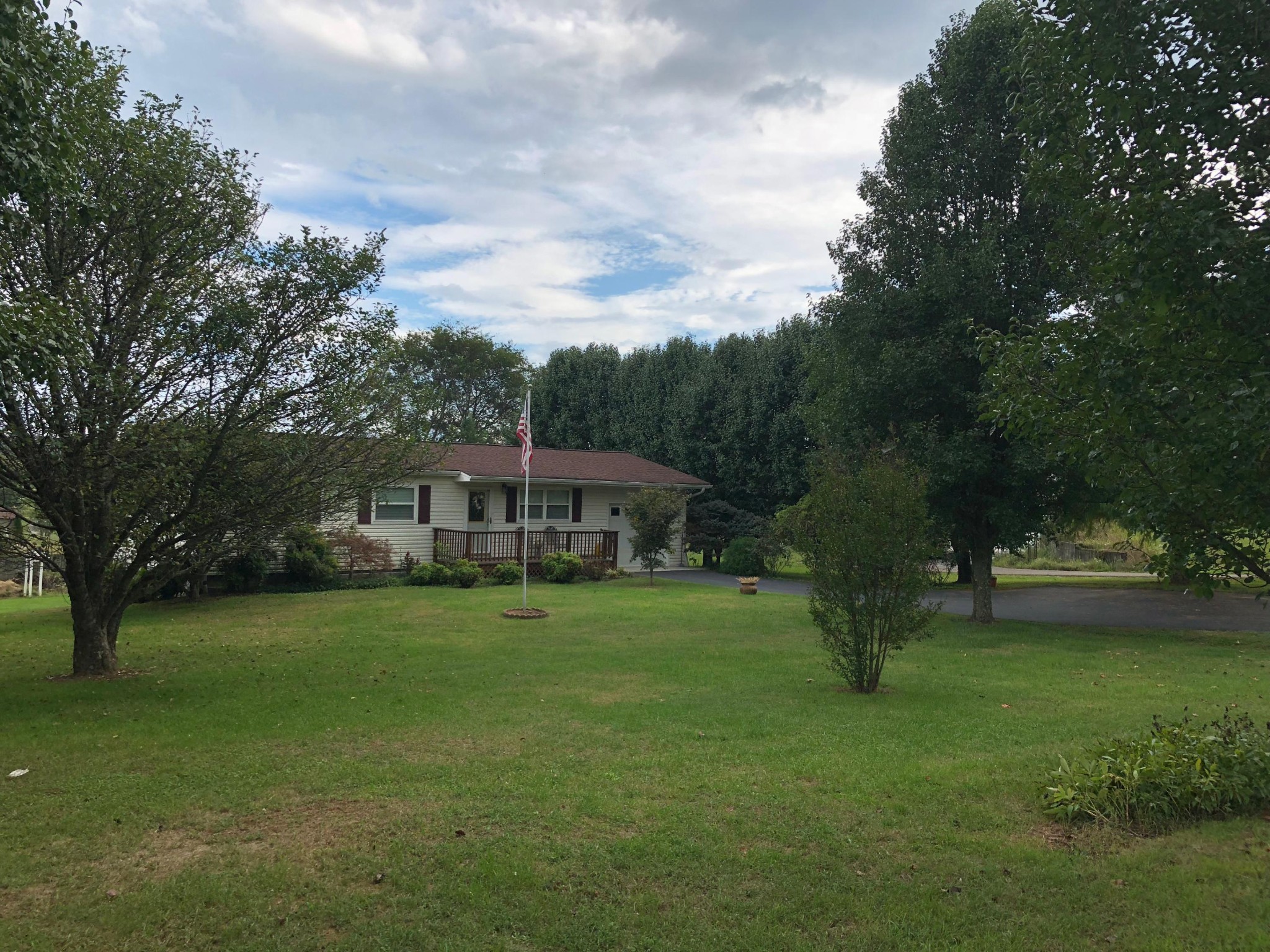 10034 Rutledge Pike Corryton, TN 37721 - Photo 7 of 10 a view of a house with a big yard