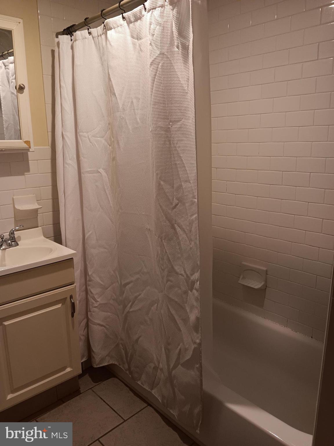 712 Central Avenue, Unit B Glendora, NJ 08029 - Photo 11 of 11 a bathroom with a shower and a sink