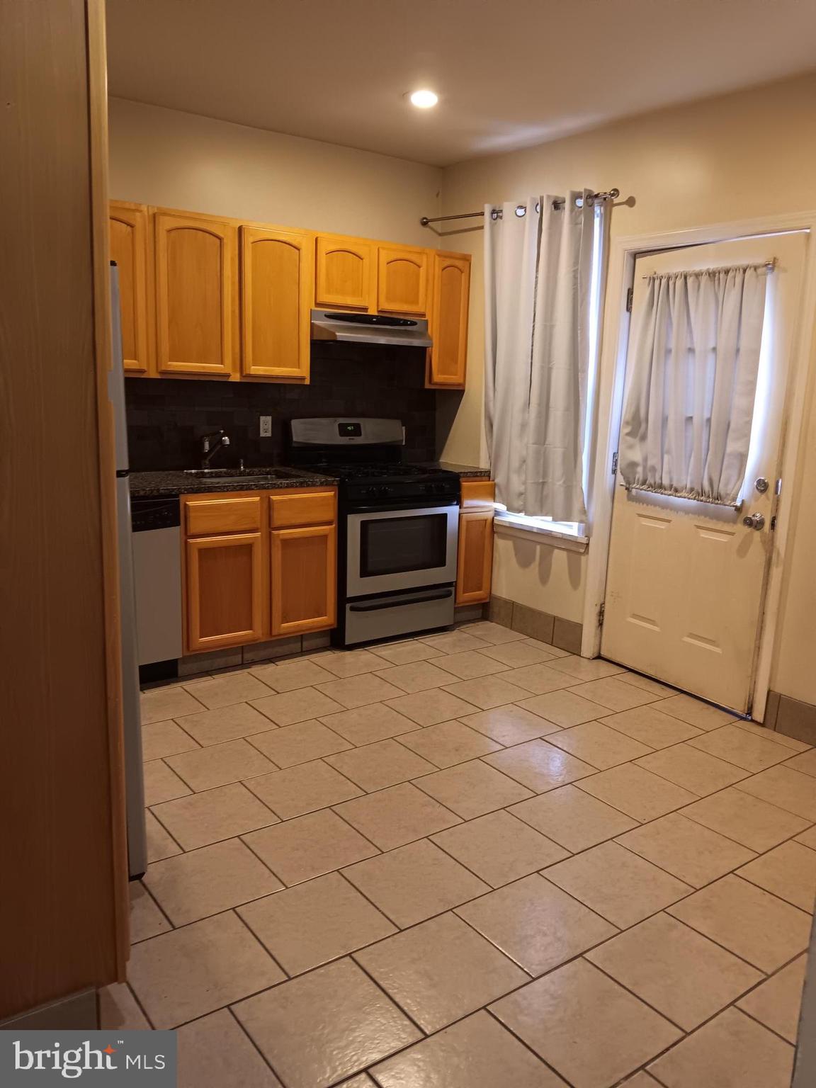712 Central Avenue, Unit B Glendora, NJ 08029 - Photo 2 of 11 a kitchen with stainless steel appliances a refrigerator and a stove top oven